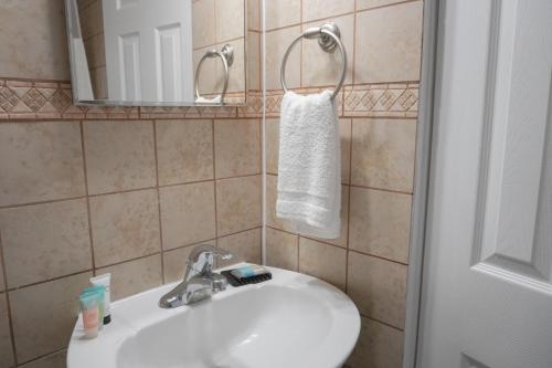 a bathroom with a white sink and a mirror at Pier Point in Wildwood