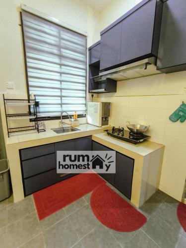 a kitchen with a run homeless sign on the floor at RumaHomestay in Pekan