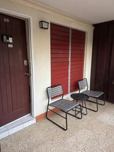 two chairs and a table next to a door at Oxford Manor Apt - Kingston - Economy stay in Kingston