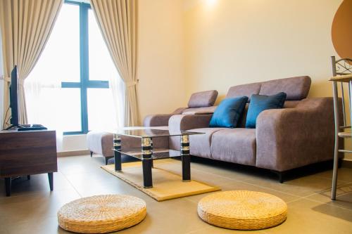 a living room with a couch and a table at 6Muji 2room 5min to 1U&Ikea with SkyPool at EmpireCity by Light House in Petaling Jaya