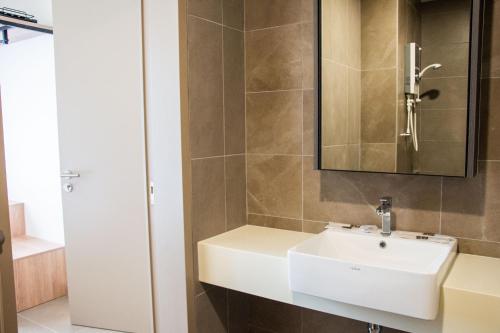a bathroom with a white sink and a mirror at 6Muji 2room 5min to 1U&Ikea with SkyPool at EmpireCity by Light House in Petaling Jaya