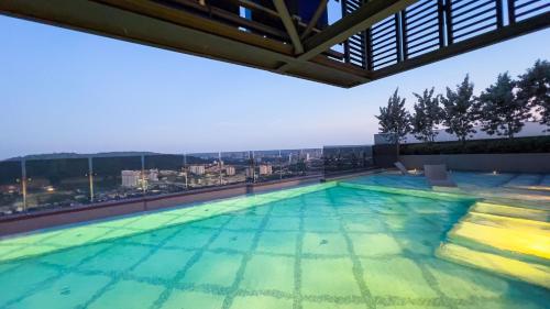 a swimming pool on the roof of a building at 6Muji 2room 5min to 1U&Ikea with SkyPool at EmpireCity by Light House in Petaling Jaya
