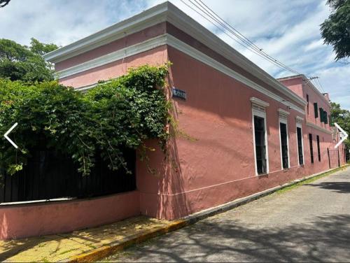 a pink building on the side of a street at Las Flores in San Isidro