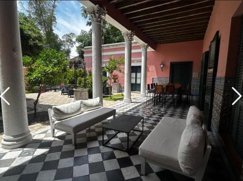a patio with couches and tables on a house at Las Flores in San Isidro