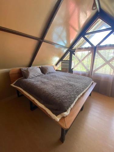 a bedroom with a large bed in a tent at New Private Rooms in Haole Santa Fe in General Luna