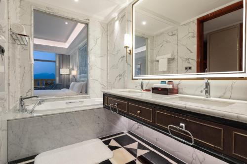 a bathroom with two sinks and a large mirror at Wyndham Taian West in Tai'an