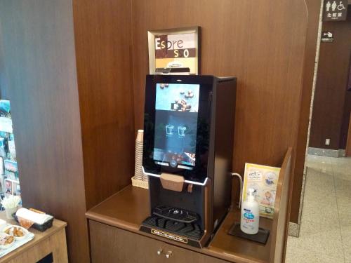 a tv on top of a table in a room at Hotel Route-Inn Iyo-Saijo in Saijo