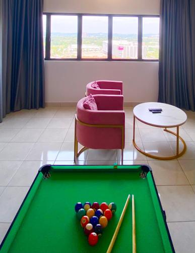 a room with a pool table and a chair at Studio with Rooftop Pool at Youth City Nilai by D'KAY HOMES, near USIM KLIA in Nilai
