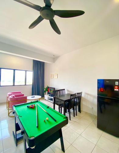 a living room with a pool table and a ceiling fan at Studio with Rooftop Pool at Youth City Nilai by D'KAY HOMES, near USIM KLIA in Nilai