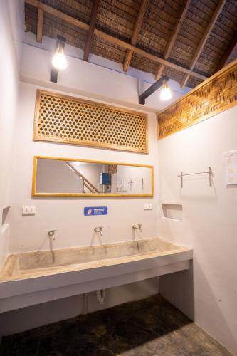 a bathroom with two sinks and a mirror at New Private Rooms in Haole Santa Fe in General Luna