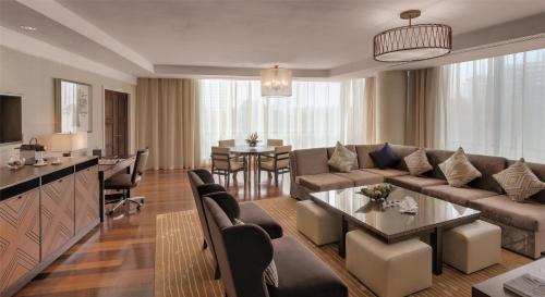 a living room with a couch and a table at Kempinski Hotel Gold Coast City in Accra