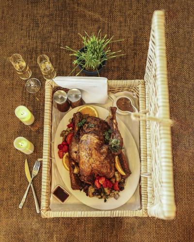 a plate of food with a roast chicken and vegetables at Kempinski Hotel Gold Coast City in Accra