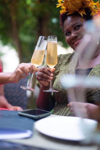 a group of people holding champagne glasses at a table at Kempinski Hotel Gold Coast City in Accra