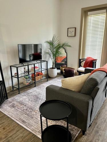 a living room with a couch and a table at Mi Casa es su Casa in Dallas