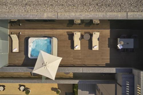 an overhead view of a building with a pool and an umbrella at Hotel Kempinski Palace Portorož in Portorož
