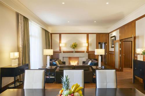 a living room with a couch and a fireplace at Hotel Kempinski Palace Portorož in Portorož