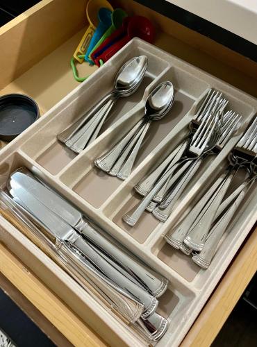 a tray of silver utensils in a drawer at Mi Casa es su Casa in Dallas