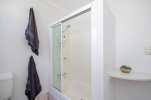 a bathroom with a shower with a glass door at Holiday Haven @ North Haven - club, river, beach in North Haven