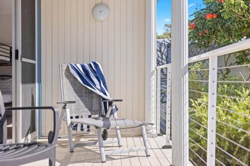 a rocking chair on the porch of a house at Holiday Haven @ North Haven - club, river, beach in North Haven