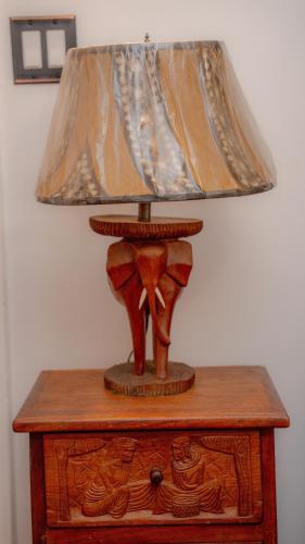 a lamp sitting on top of a wooden table at African Oasis Luxury Inn at the Gallery in Mount Vernon