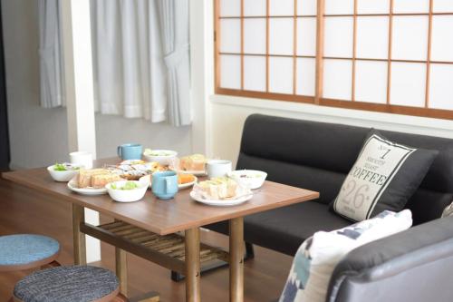 a table with bowls of food on top of it at INUYAMA BASE Vacation rental in Inuyama