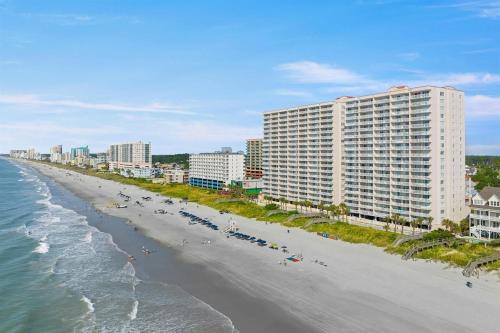 an aerial view of a beach with buildings and the ocean at Oceanfront Crescent Shores #208-Sleeps 10 3bed 3bath 28 Foot Balcony in North Myrtle Beach