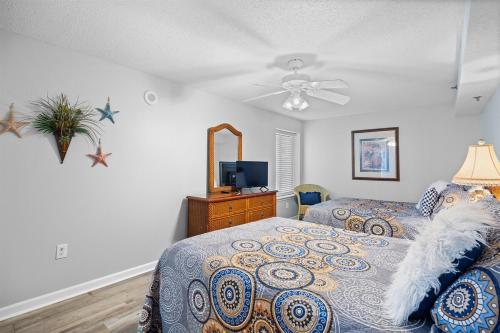 a bedroom with two beds and a ceiling fan at Oceanfront Crescent Shores #208-Sleeps 10 3bed 3bath 28 Foot Balcony in North Myrtle Beach