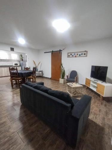 a living room with a black couch and a table at Cruz del Sur in Santa Rosa