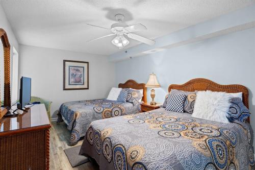 a bedroom with two beds and a ceiling fan at Oceanfront Crescent Shores #208-Sleeps 10 3bed 3bath 28 Foot Balcony in North Myrtle Beach