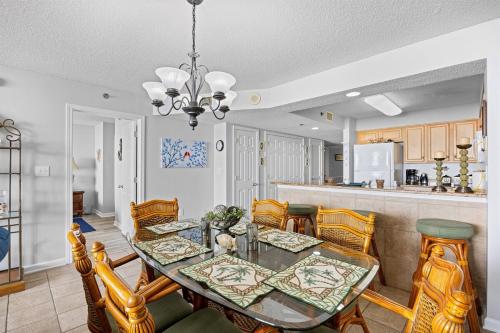 a dining room and kitchen with a table and chairs at Oceanfront Crescent Shores #208-Sleeps 10 3bed 3bath 28 Foot Balcony in North Myrtle Beach