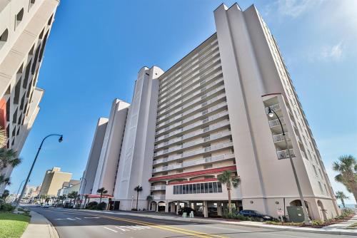 a large white building on a city street at Oceanfront Crescent Shores #208-Sleeps 10 3bed 3bath 28 Foot Balcony in North Myrtle Beach