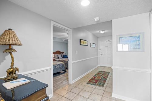 a room with a table with a lamp and a bedroom at Oceanfront Crescent Shores #208-Sleeps 10 3bed 3bath 28 Foot Balcony in North Myrtle Beach