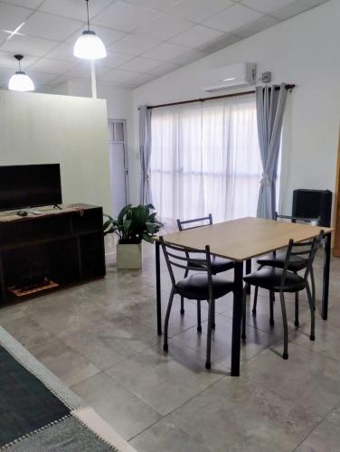 a table and chairs in a room with a fireplace at Cruz del Sur in Santa Rosa
