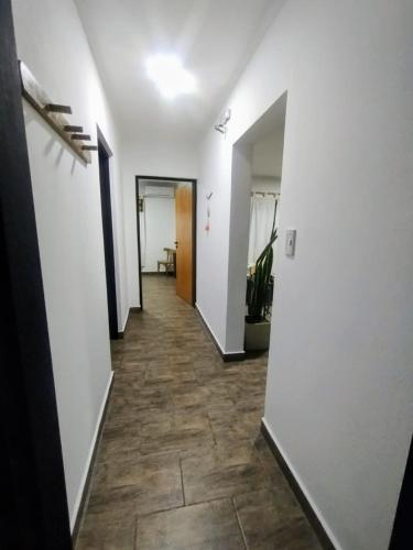 a hallway with white walls and a tile floor at Cruz del Sur in Santa Rosa