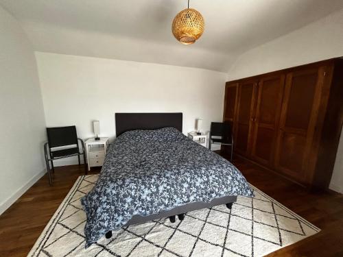 a bedroom with a bed and two tables and two chairs at Maison Rénovée avec Jardin et WIFI à La Roche-Posay - FR-1-541-173 in La Roche-Posay