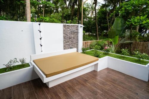a white bench sitting on top of a patio at Vida Homes Sipalay in Sipalay