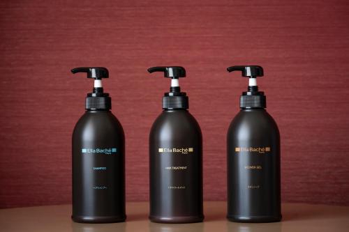 three black bottles sitting on top of a table at Tokyo Prince Hotel in Tokyo