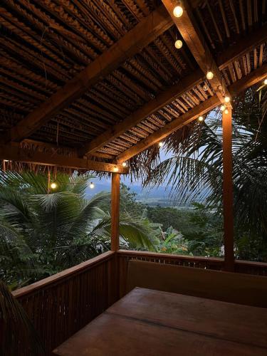 a wooden porch with a view of the jungle at Amazon Paradise WiFi Starlink Work or Relax in Morales