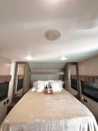 a bedroom with a large bed with two shoes on it at La Gozadera Park RV 1 in Salinas