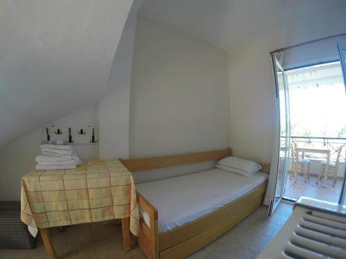 a small bedroom with a bed and a table at Elia Apartments in Oreoi