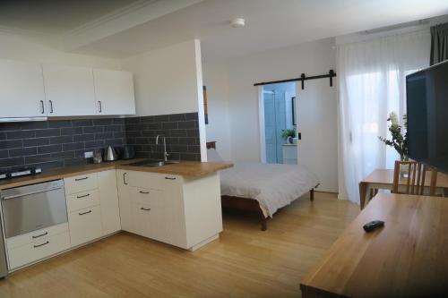 a room with a kitchen and a bed in a room at St Caths Anchorage in Brisbane