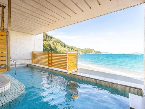 a swimming pool with a view of the ocean at Nichinankaigan Nango Prince Hotel in Nichinan