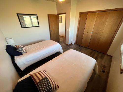 a small room with two beds and a closet at Relaxing Getaway - Fun at the Lake in Pierre