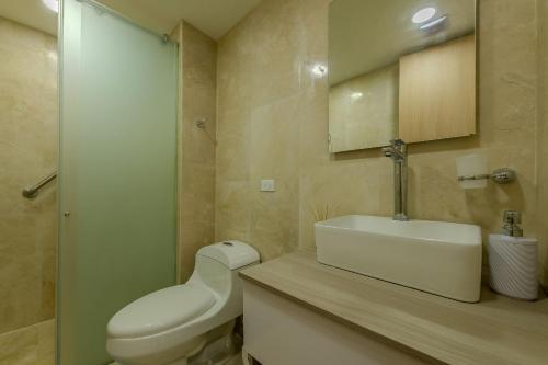 a bathroom with a white toilet and a sink at Cartagena Beach Resort 1133 in Cartagena de Indias