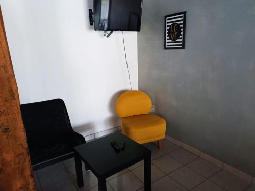 a living room with a chair and a table at La French Pause - Tarifs dégressifs - Idéal PROS in Champniers-et-Reilhac