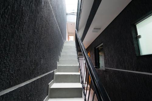 a stairway leading up to a building with white stairs at Hostel Village GRU in Guarulhos