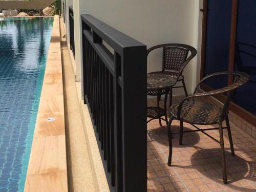 a black fence next to a swimming pool at The Green Hotel in Ko Lipe
