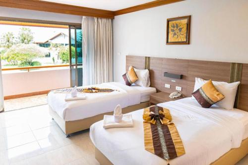 Ένα ή περισσότερα κρεβάτια σε δωμάτιο στο The Impress Nan Hotel