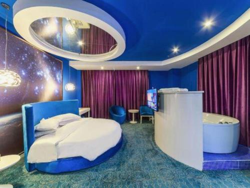 a bedroom with a bed and a bath tub at TO915101 STILL LOVE THEME HOTEL in Chengdu