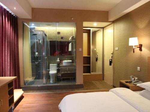 a bedroom with a bathroom with a shower and a toilet at Pankun Business Hotel in Kunming